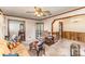 Warm living room with vintage details, including a ceiling fan, display cabinet, and cozy furniture at 1009 N Main St, Mount Holly, NC 28120