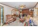 Cozy living room featuring a classic brick fireplace, ceiling fan, and comfortable seating area at 1009 N Main St, Mount Holly, NC 28120