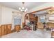 View of living room with natural light, vintage furniture, and a decorative brick fireplace in background at 1009 N Main St, Mount Holly, NC 28120