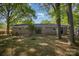 Brick house backyard with sliding glass doors, fire pit, and beautiful trees at 1141 Carolina Cir, Statesville, NC 28677