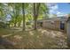 Spacious backyard with large trees, a hammock, and brick back of house at 1141 Carolina Cir, Statesville, NC 28677