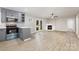 Open-concept living space boasts wood floors, a cozy fireplace, and double doors leading to the outdoors at 1141 Carolina Cir, Statesville, NC 28677