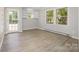 Bright sunroom with multiple windows and door to backyard, offering natural light and outdoor access at 1141 Carolina Cir, Statesville, NC 28677