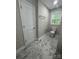 Cozy bathroom featuring modern fixtures and sleek marble-look tile flooring at 117 Woodland Ave, Shelby, NC 28152