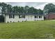 Charming painted brick home with a manicured lawn and lovely black shutters at 117 Woodland Ave, Shelby, NC 28152
