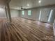 Finished living room featuring new wood floors, neutral paint, natural light, and a ceiling fan at 117 Woodland Ave, Shelby, NC 28152