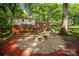 Large backyard featuring a fire pit, manicured landscaping, and an expansive deck at 118 Spicewood Cir, Troutman, NC 28166