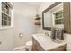 Clean bathroom with a modern vanity, decorative mirror, and stylish fixtures at 118 Spicewood Cir, Troutman, NC 28166