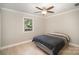 A cozy bedroom featuring natural light, a ceiling fan, and hardwood floors at 118 Spicewood Cir, Troutman, NC 28166