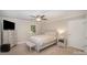 A serene bedroom with a ceiling fan, natural light, and a decorative queen sized bed at 118 Spicewood Cir, Troutman, NC 28166