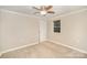 An empty bedroom featuring neutral walls and carpet, a single window, and simple decor at 118 Spicewood Cir, Troutman, NC 28166
