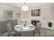 Elegant dining room featuring a fireplace, stylish decor, and seating for four around a round table at 118 Spicewood Cir, Troutman, NC 28166