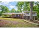 Charming brick and siding home with a covered carport and landscaped front yard under a sunny sky at 118 Spicewood Cir, Troutman, NC 28166