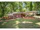 Brick home with a covered carport, chimney and a manicured lawn surrounded by mature trees at 118 Spicewood Cir, Troutman, NC 28166