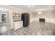 Open kitchen with white cabinets, stainless steel appliances, and a fireplace adjacent to a breakfast nook at 118 Spicewood Cir, Troutman, NC 28166