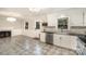 Well-lit kitchen featuring updated appliances, a sleek backsplash, granite countertops, and tiled floors at 118 Spicewood Cir, Troutman, NC 28166