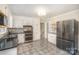 Spacious kitchen featuring stainless steel appliances, granite countertops, and ample storage space with white cabinetry at 118 Spicewood Cir, Troutman, NC 28166