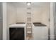 A well-equipped laundry room with two modern, front-load washing machines and storage at 118 Spicewood Cir, Troutman, NC 28166