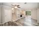 Open living room with stairs, shelving, and a sliding door to the backyard at 118 Spicewood Cir, Troutman, NC 28166