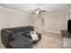 Bright living room featuring hardwood floors, a ceiling fan, and a comfortable sectional sofa with ottoman at 118 Spicewood Cir, Troutman, NC 28166