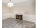 Cozy living room featuring a fireplace with decorative tile surround and a modern light fixture at 118 Spicewood Cir, Troutman, NC 28166