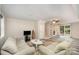 Bright living room featuring a couch, TV, stairs, and sliding glass door to the backyard at 118 Spicewood Cir, Troutman, NC 28166