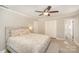 Comfortable main bedroom with neutral tones, a ceiling fan, and a plush, decorative king sized bed at 118 Spicewood Cir, Troutman, NC 28166