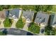 Aerial view of three houses with well-manicured lawns and mature trees in a suburban neighborhood at 1365 Winged Foot Dr, Denver, NC 28037