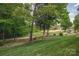 Expansive backyard view overlooking a golf course with mature trees and lush green grass at 1365 Winged Foot Dr, Denver, NC 28037