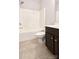 Bathroom featuring dark vanity, matching toilet and tiled tub and shower combo at 1365 Winged Foot Dr, Denver, NC 28037