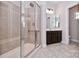 Bathroom featuring glass enclosed shower, tile surround and floors plus a dark vanity at 1365 Winged Foot Dr, Denver, NC 28037