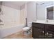 Bathroom featuring neutral walls, a vanity with a dark wood cabinet, a toilet, and a shower-tub combo at 1365 Winged Foot Dr, Denver, NC 28037