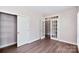Bedroom with hardwood floors, closet with wire shelving and glass panel french doors at 1365 Winged Foot Dr, Denver, NC 28037