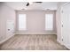 Spacious bedroom featuring neutral walls, carpet, two windows with blinds, and a ceiling fan at 1365 Winged Foot Dr, Denver, NC 28037