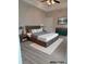 This bedroom features a wood bed frame, a ceiling fan and a dresser with modern hardware at 1365 Winged Foot Dr, Denver, NC 28037