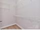Walk-in closet with white shelving and hardwood floors at 1365 Winged Foot Dr, Denver, NC 28037