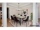 Staged dining room with modern furnishings, elegant lighting, and sophisticated decor at 1365 Winged Foot Dr, Denver, NC 28037