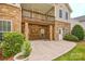 Stone facade home featuring a ground level patio and second story deck at 1365 Winged Foot Dr, Denver, NC 28037