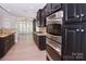 Kitchen with dark cabinetry, granite counters, and stainless appliances in an open layout at 1365 Winged Foot Dr, Denver, NC 28037