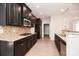 Bright, modern kitchen features dark cabinets, granite counters, and stainless appliances at 1365 Winged Foot Dr, Denver, NC 28037