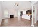Bright living room with hardwood floors, a fireplace, and an open concept layout into the kitchen at 1365 Winged Foot Dr, Denver, NC 28037