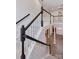 Open staircase with dark wood railings and white balusters overlooking the foyer and dining area at 1365 Winged Foot Dr, Denver, NC 28037