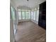 Sunroom with hardwood floors, white shutters, and natural light at 1365 Winged Foot Dr, Denver, NC 28037
