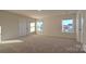 Bright, spacious carpeted bedroom with two windows, offering ample natural light at 14026 Wilson Mac Ln, Charlotte, NC 28278
