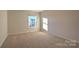Bedroom with plush carpet and a window at 14026 Wilson Mac Ln, Charlotte, NC 28278