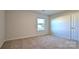Cozy bedroom featuring a window view and neutral carpeting at 14026 Wilson Mac Ln, Charlotte, NC 28278