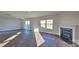 Spacious living room features hardwood-style floors, a fireplace, and natural light at 14026 Wilson Mac Ln, Charlotte, NC 28278