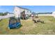 Expansive backyard featuring a covered patio, playset, trampoline and ample room to play at 1636 Tundra Ln, Denver, NC 28037