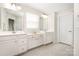 Bright bathroom featuring dual sinks, white cabinetry, and tile flooring at 1636 Tundra Ln, Denver, NC 28037