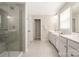 Modern bathroom with a glass shower, dual sinks, and tile flooring at 1636 Tundra Ln, Denver, NC 28037